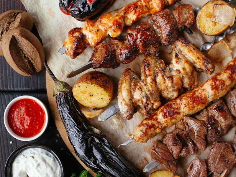 A platter of mixed lamb and chicken kebabs served over fluffy rice with grilled vegetables